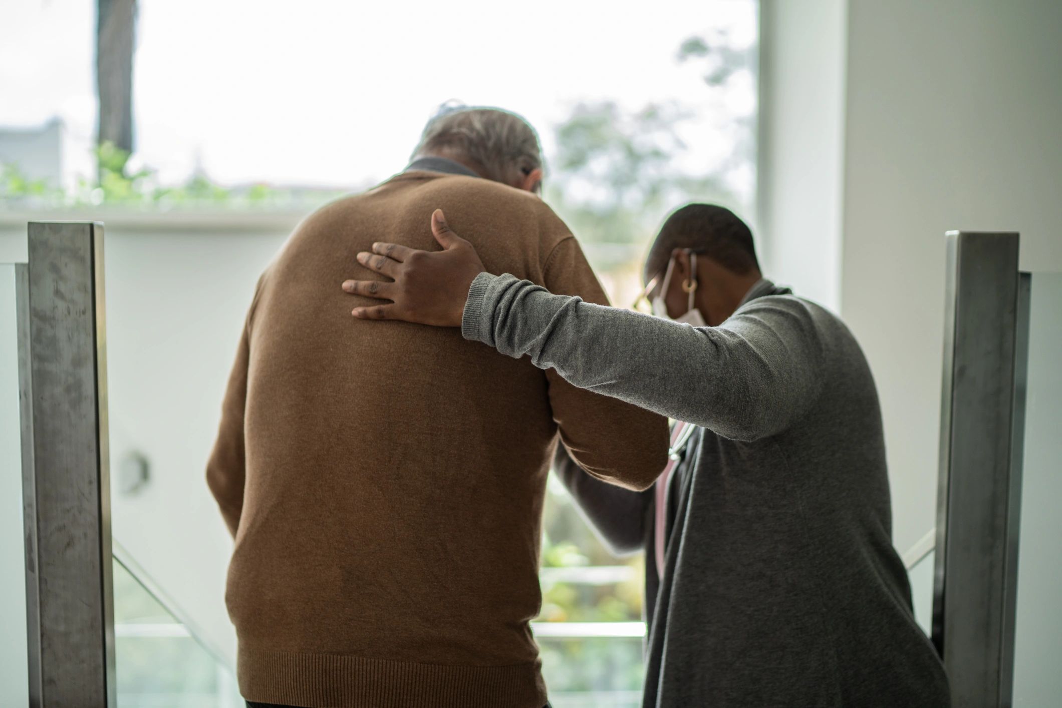 caregiver helping elderly at home
