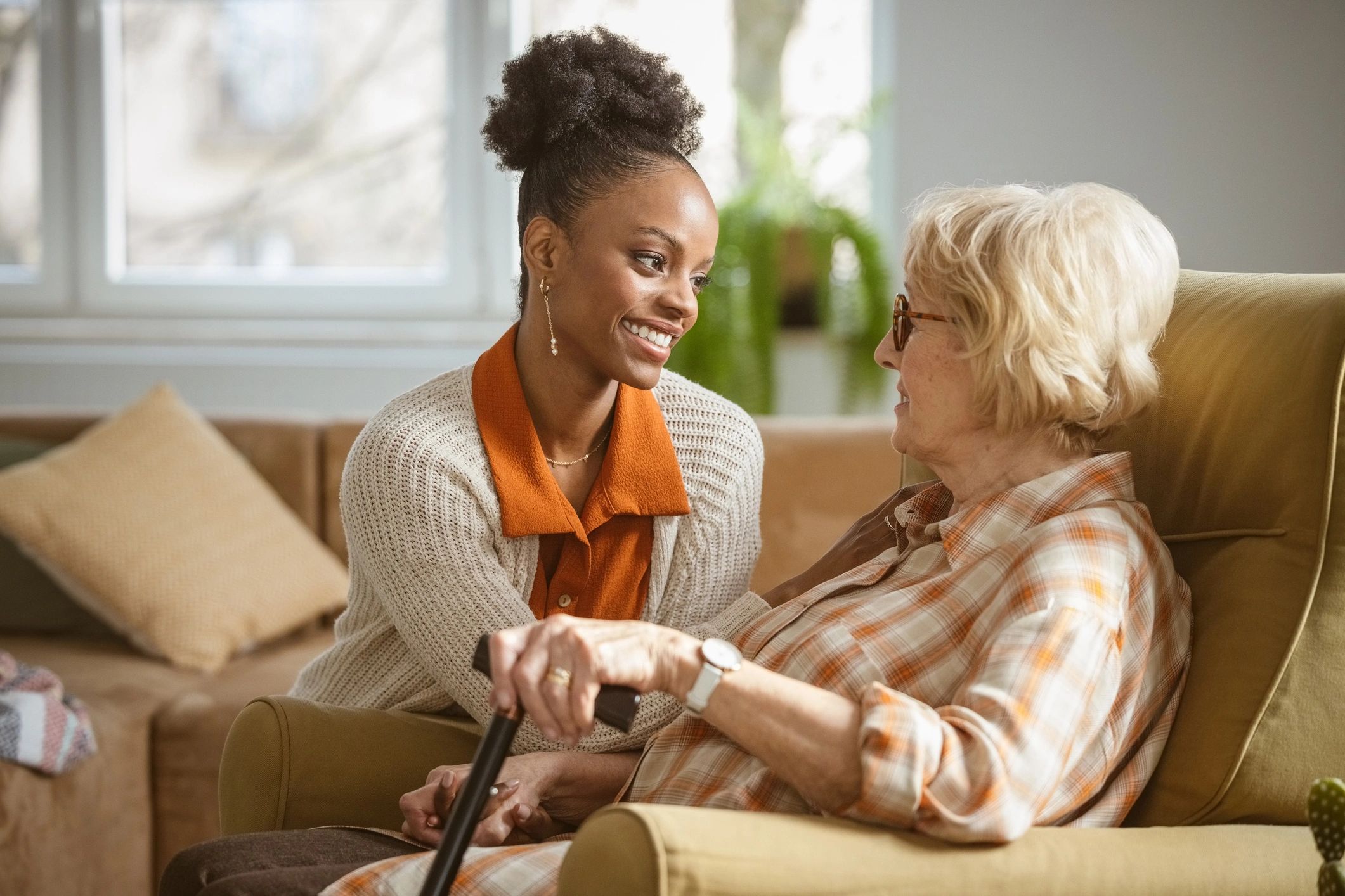 caregiver helping elderly at home
